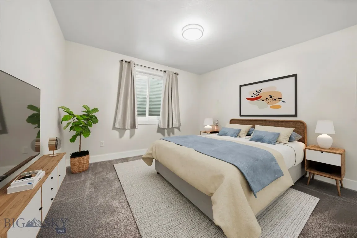 Downstairs bedroom 1. This image has been virtually staged. Furniture and decor shown for illustrative purposes only and do not convey.