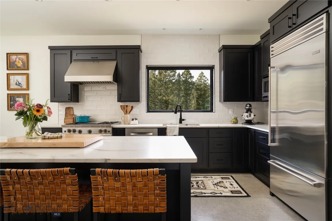 The kitchen showcases custom maple cabinetry
