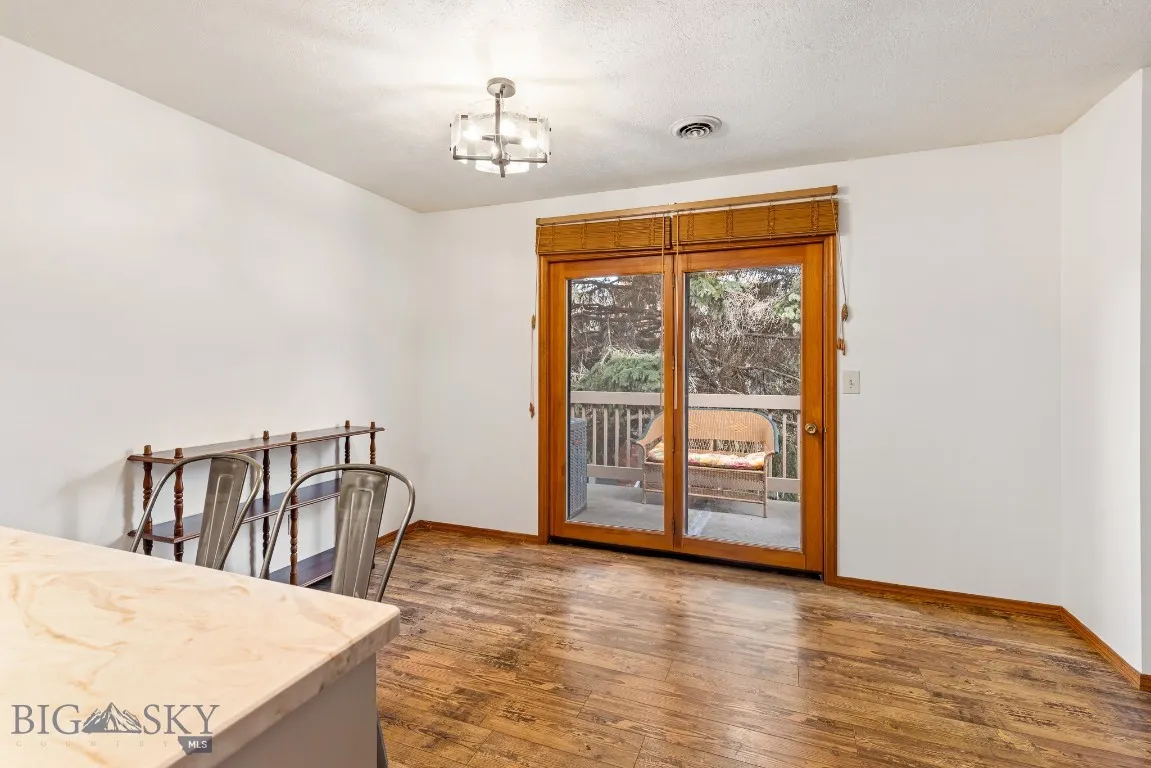 Doors lead from dining area to private deck.