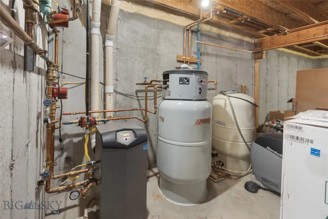 Water heater/ boiler pressure tank in basement.