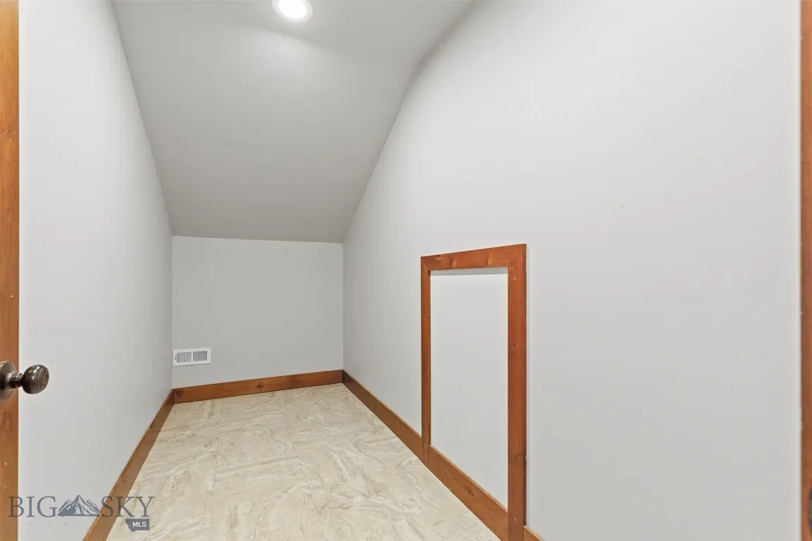 Large storage closet with attic access in bonus room.