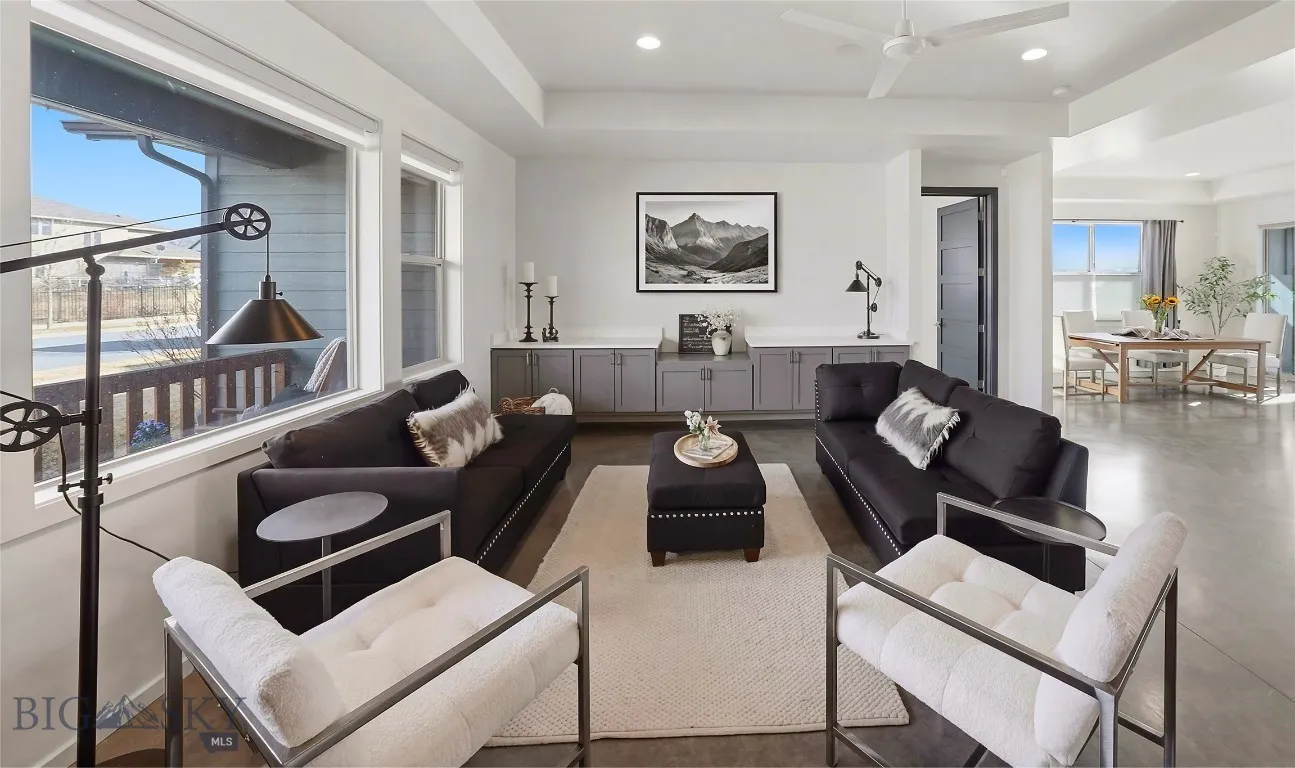 Spacious Living Room with Built-in Cabinets, large windows letting light stream in...