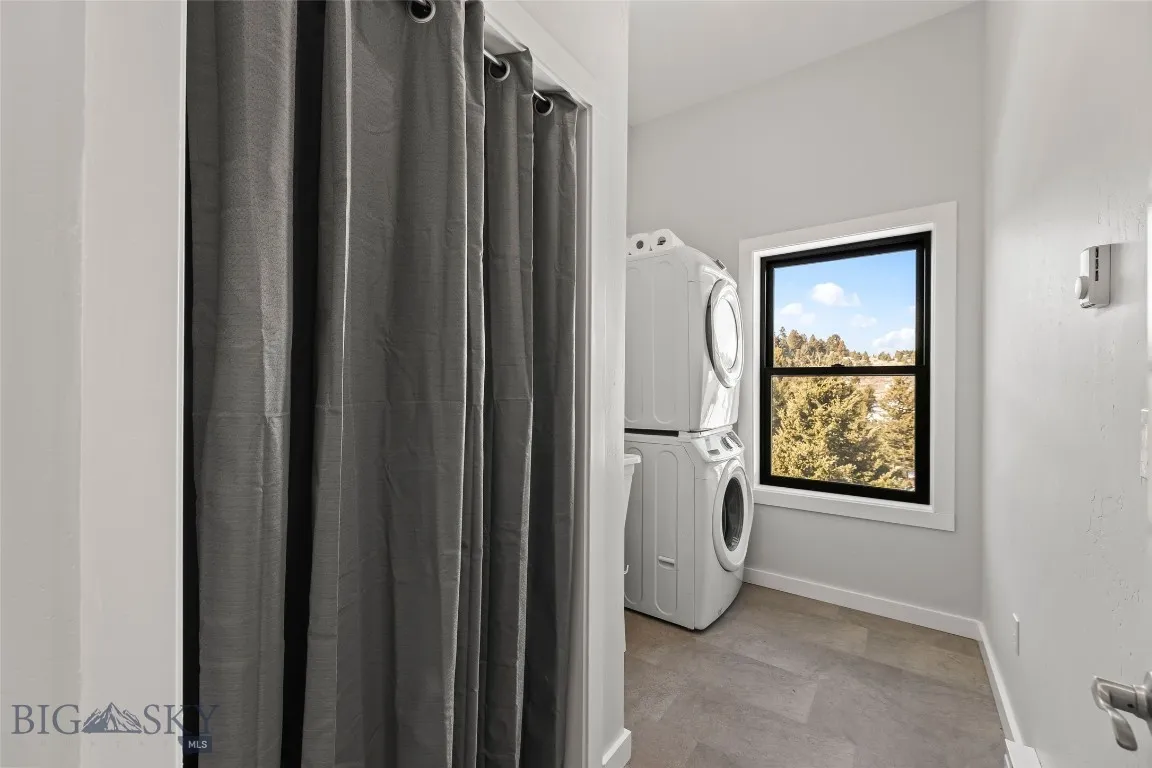 Upstairs dedicated laundry room with storage area