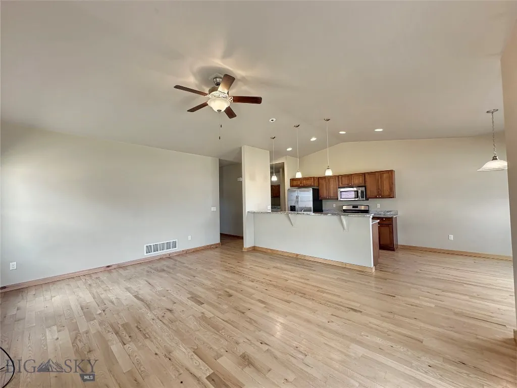 Living Room to Kitchen - note vaulted ceiling