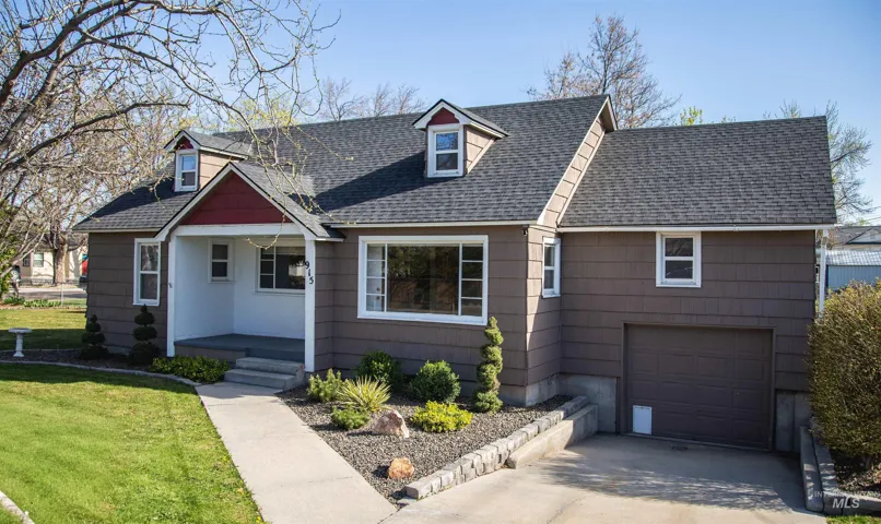 Cape cod home featuring an attached garage, roof with shingles, driveway, a front lawn, and a porch