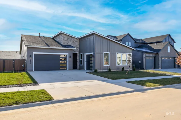 Contemporary gray exterior with vertical board and batten siding and stone accents