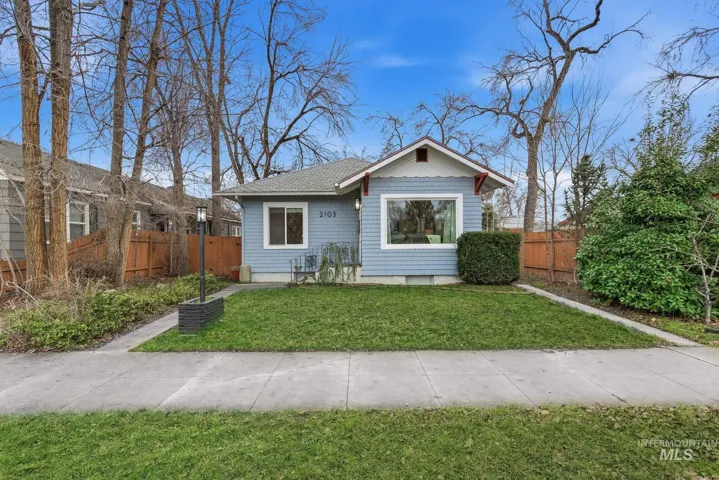 Bungalow-style house with a fenced backyard