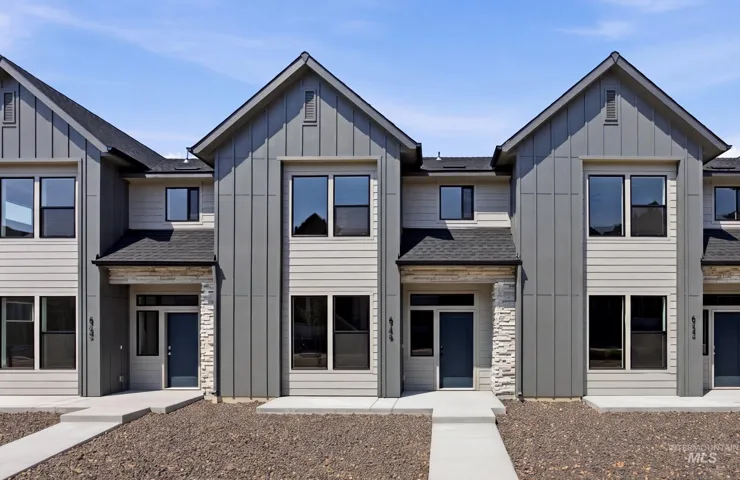 Modern townhome facade featuring a prominent gabled roofline