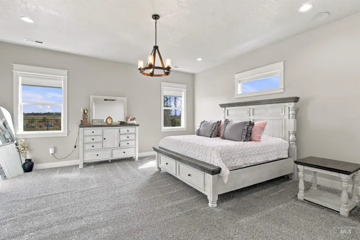 Recessed lighting, chandelier, and multiple windows