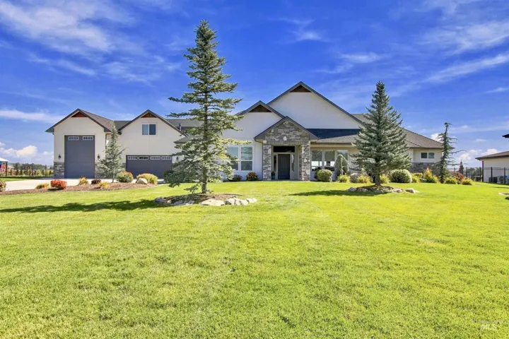 Contemporary exterior with stone accents and multiple garage bays