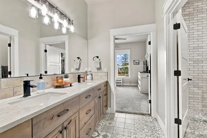 Double vanity with integrated sinks, stone-look countertop, and wood-finish cabinetry