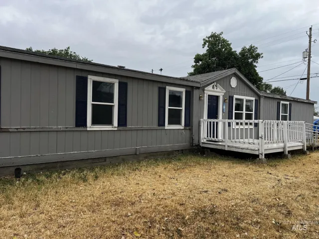 Gray exterior siding with white trim and dark blue shutters