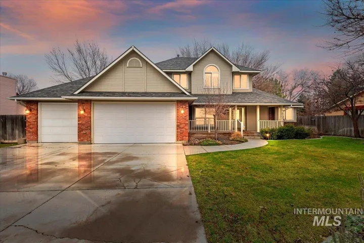 View of front of house with a porch, concrete driveway, a garage, a shingled roof, and brick siding
