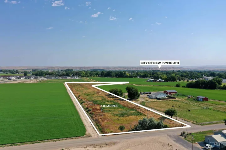 Aerial view of sparsely populated area with property parcel outlined and abundant farmland