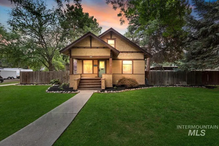 Craftsman-style home featuring a covered front porch, a gabled roofline, and visible wood trim details