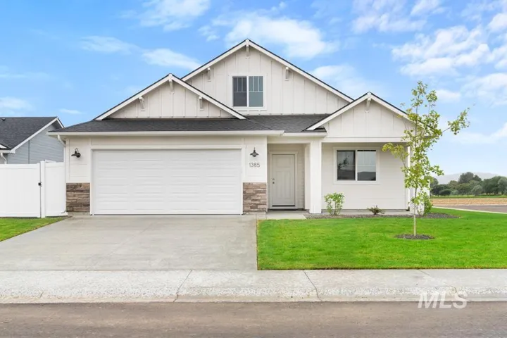 White siding exterior with board and batten accents, a two-car garage, and stone veneer detailing