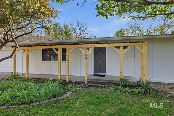 View of front facade featuring a garage and a porch