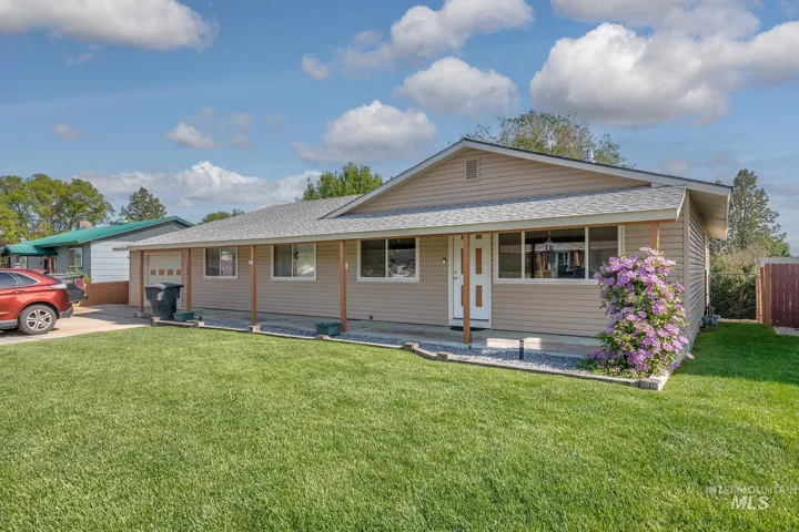 Ranch-style exterior with neutral siding and a light gray roof