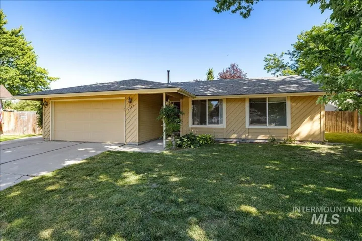 Ranch-style home with a garage and concrete driveway