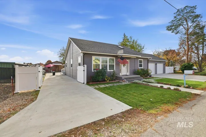 View of front facade featuring driveway with double gate a gate, 6+ vehicles for parking