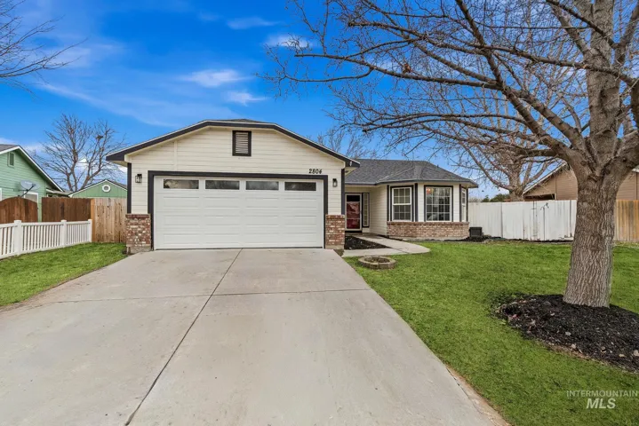 Ranch-style house with brick siding, driveway, and an attached garage