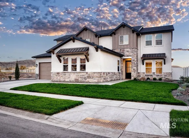 Modern two-story residence featuring a mixed-material exterior with stone and fiber cement accents, paired gabled rooflines with dark asphalt shingles, and substantial multi-pane windows