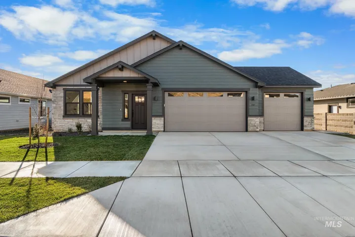 Single-story exterior featuring board-and-batten siding, stone veneer accents, a three-car garage, and a covered front entryway