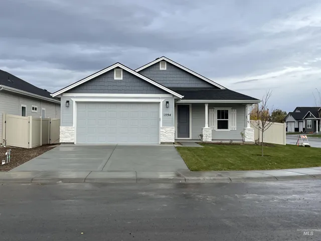 Craftsman house with covered porch, concrete driveway, a garage, stone siding, and roof with shingles