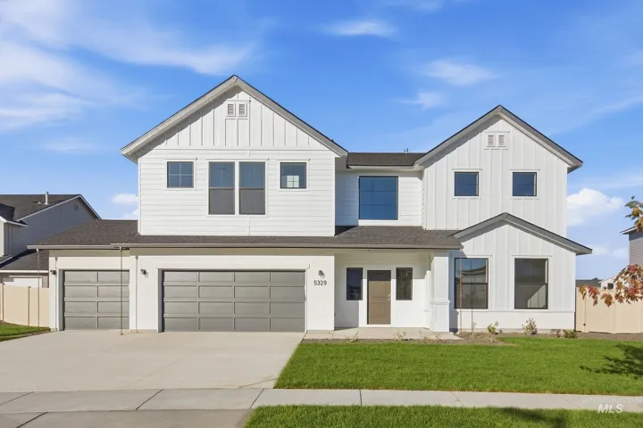 Contemporary two-story residence featuring white board and batten siding, multiple gables, and a dark shingle roof