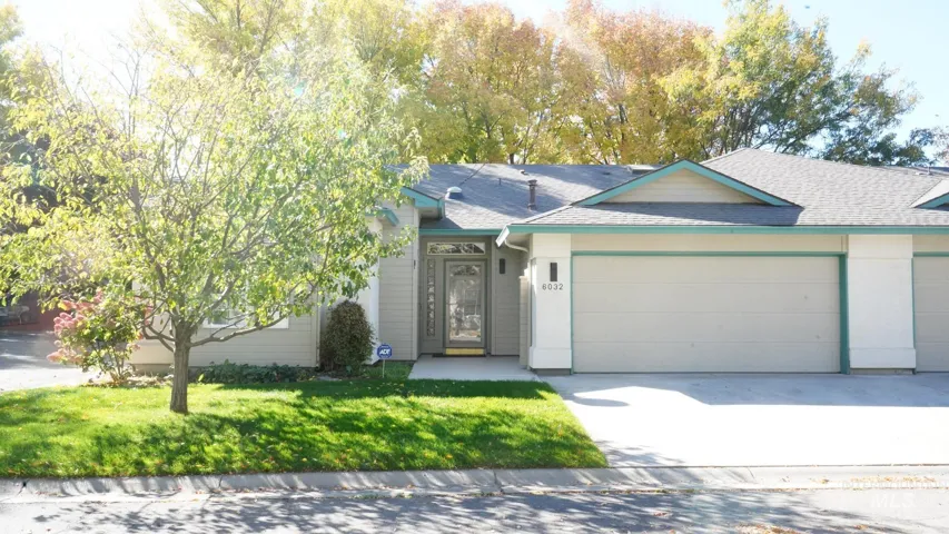 Single-story exterior featuring horizontal siding, a multi-car garage with overhead doors, a paved driveway, and a front entry with a glass-paneled door