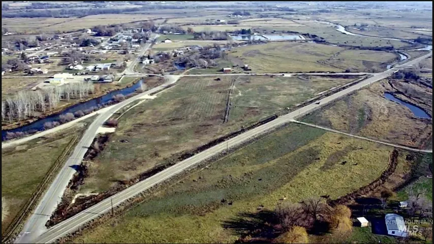 Aerial view of property's location featuring rural landscape and a large body of water