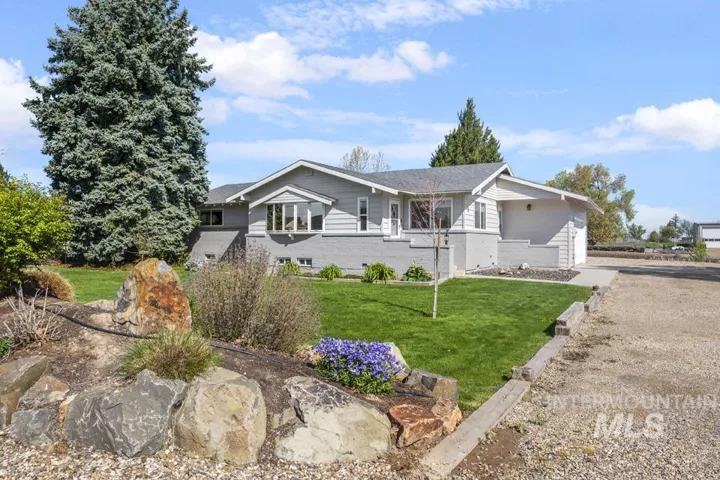 Ranch-style exterior with gray siding and brick accents