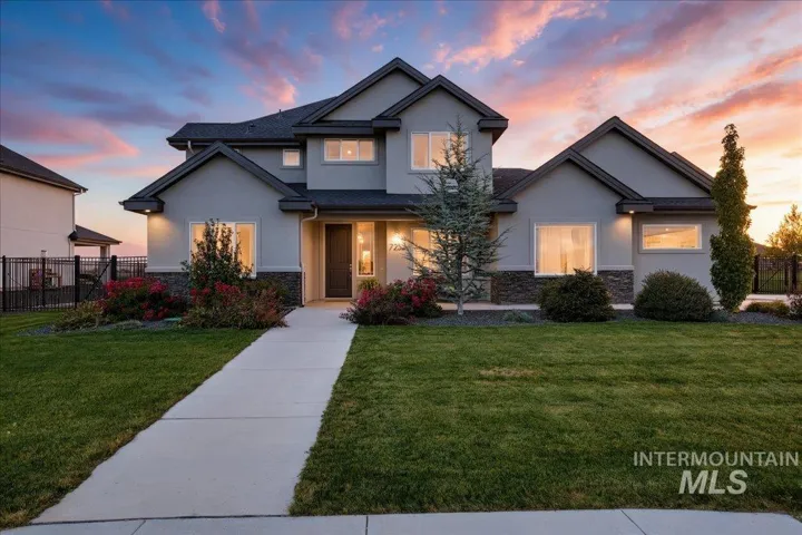 Stucco exterior with dark trim and stone accents