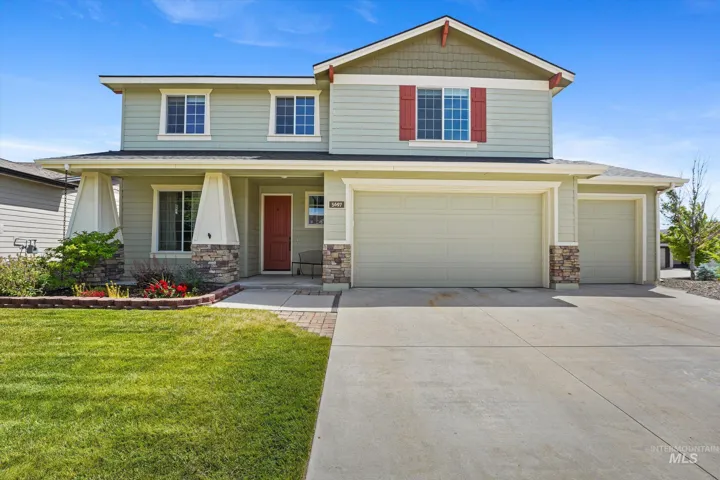 Two-story residence featuring light green siding and contrasting red shutters