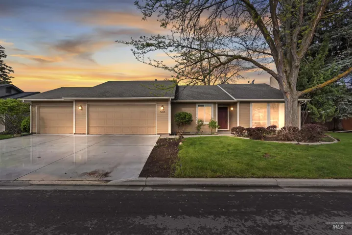 Ranch-style house with an attached garage, concrete driveway, a front lawn, and a shingled roof