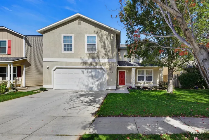 Two-story exterior with a stucco finish, attached garage, and a concrete driveway