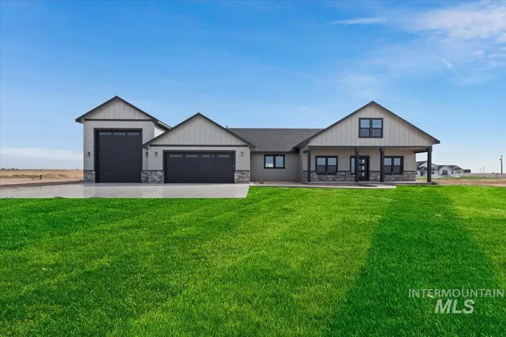 Modern farmhouse-inspired exterior with light-colored siding and dark trim