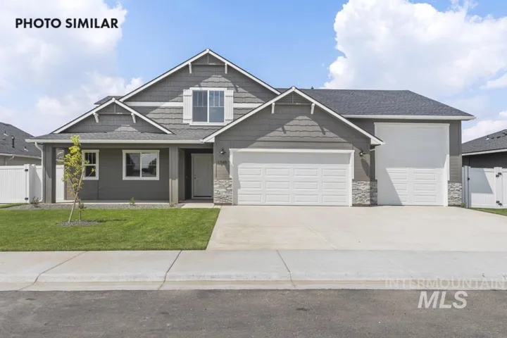 Gray siding exterior with white trim accents and stone detailing, featuring a two-car garage, an additional single-car garage, and a covered front porch