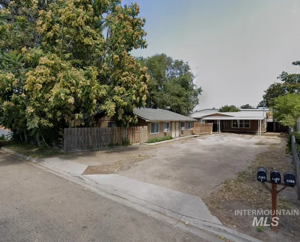 View of front of house with asphalt driveway