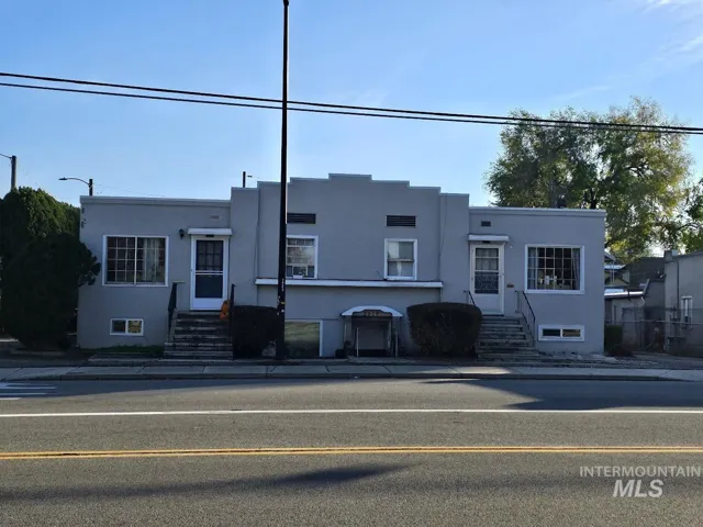 View of front facade featuring stucco siding and entry steps