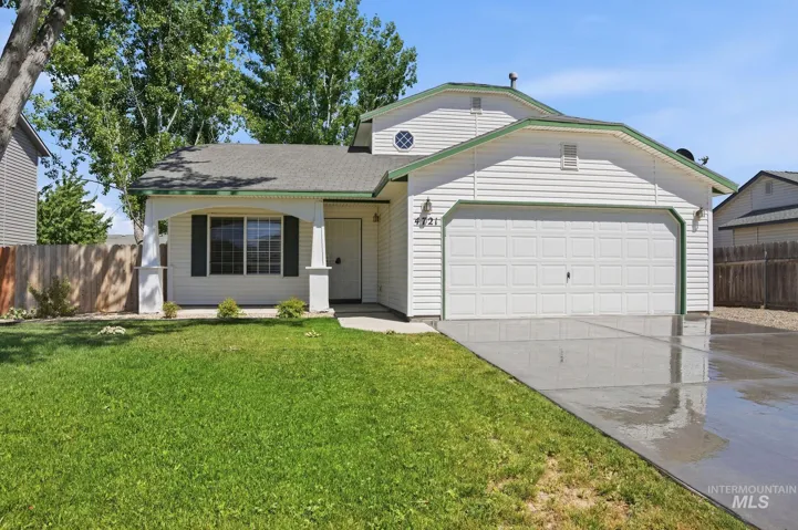 White siding exterior with a prominent two-car garage