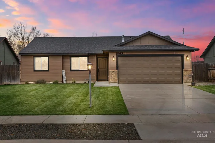 Ranch-style house with an attached garage, a shingled roof, driveway, and stone siding