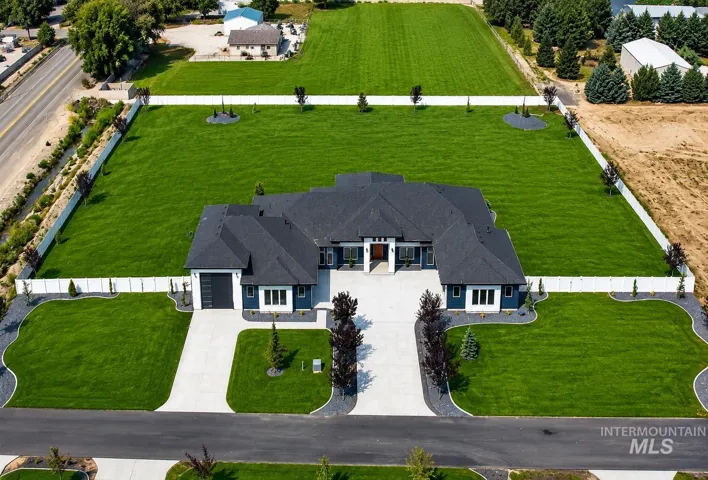 Striking modern residence showcasing a dramatic dark roof and clean-lined architectural design with a symmetrical façade