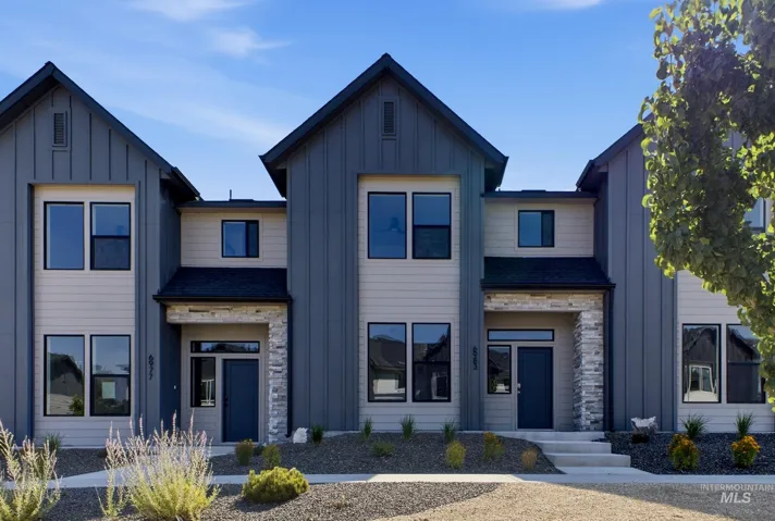 Modern facade featuring vertical board and batten siding, horizontal siding, and stone accents