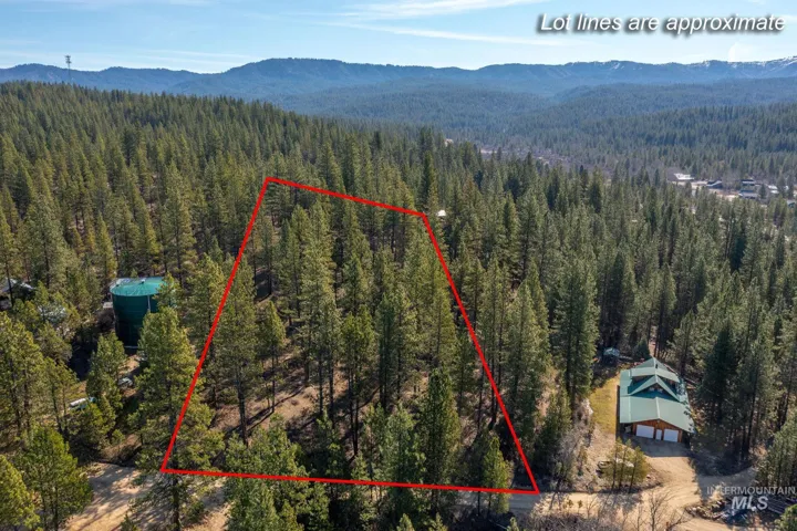 Aerial view of property's location featuring a mountainous background and property boundaries highlighted