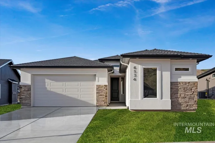 Contemporary single-story residence featuring a two-car garage, concrete driveway, and a stone facade accent