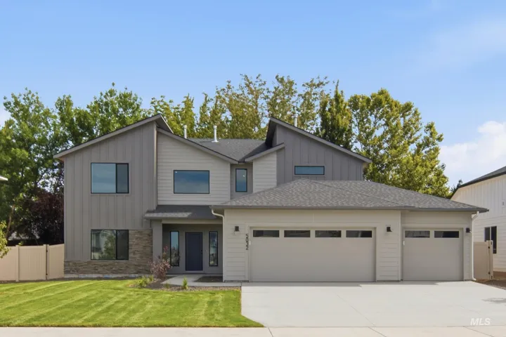 Contemporary exterior featuring a multi-tone siding, stone accents, and an attached two-car garage