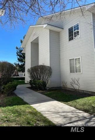 View of property exterior with a yard