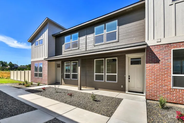 View of front of property featuring board and batten siding and brick siding