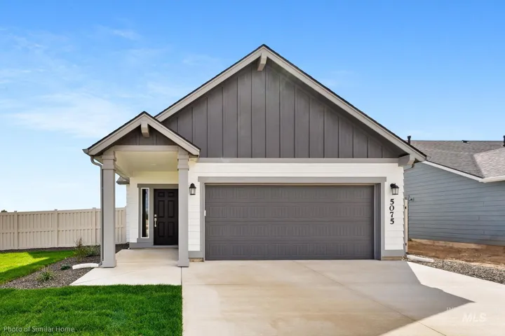 View of front facade with an attached garage, board and batten siding, and driveway
